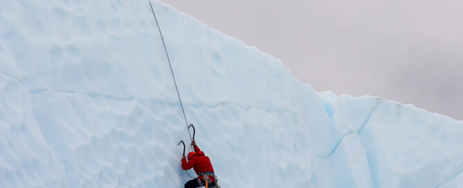 two people climbing an ice wall
