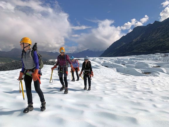a family walking on glacier ice