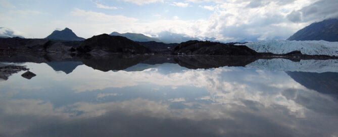 reflection of sky on glacier meltwater