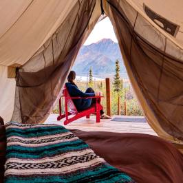 Women sitting in a red wooden chair