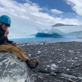 Child sitting on a rock on the Matanuska glacier