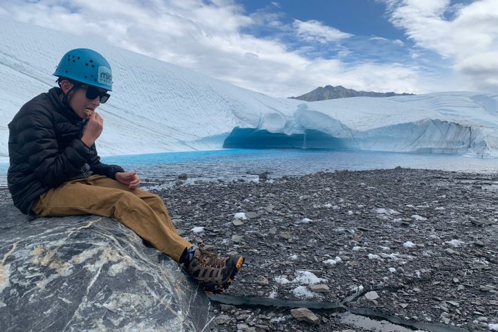 Child sitting on a rock on the Matanuska glacier