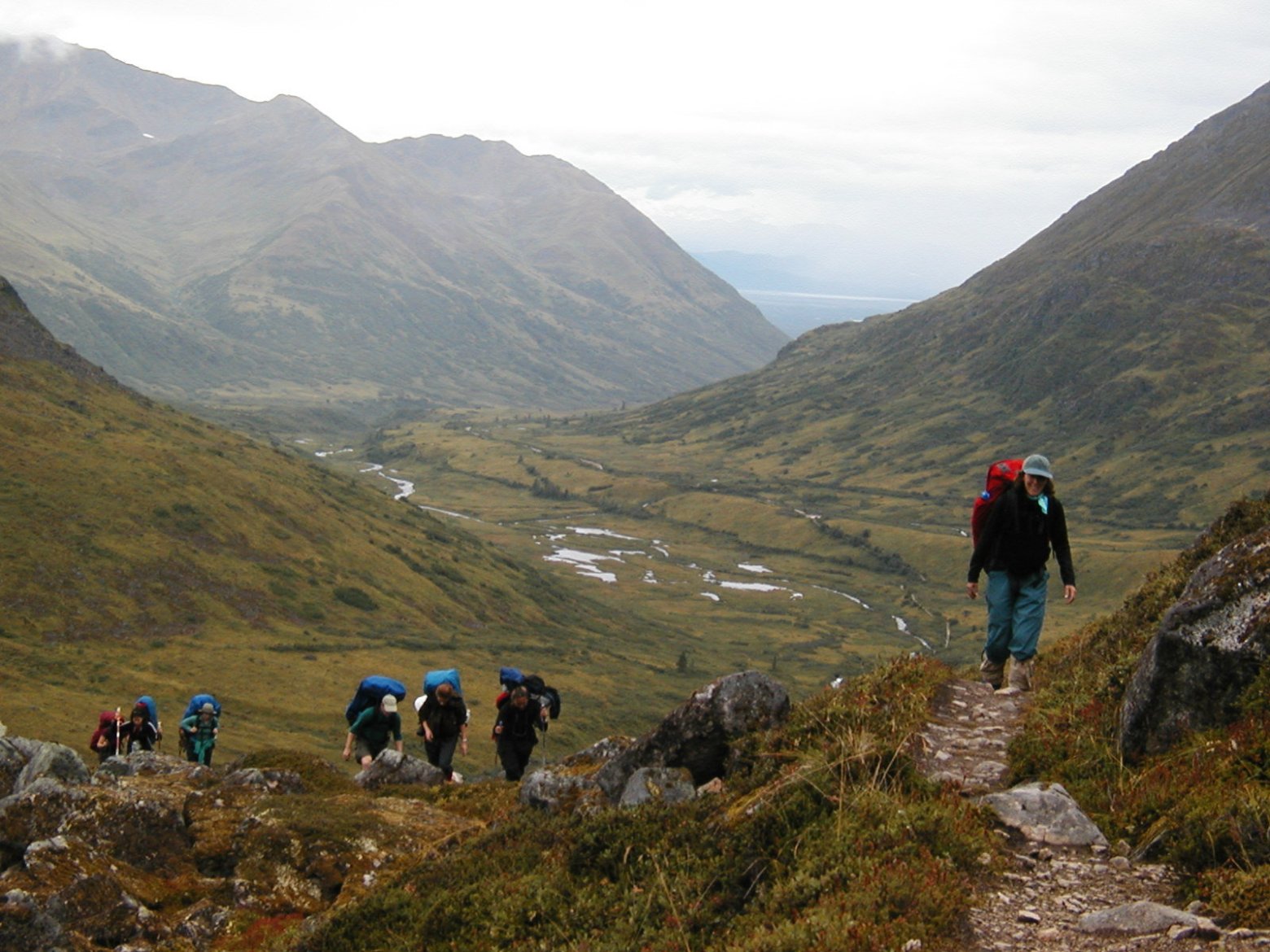 a group of people walking up a hill