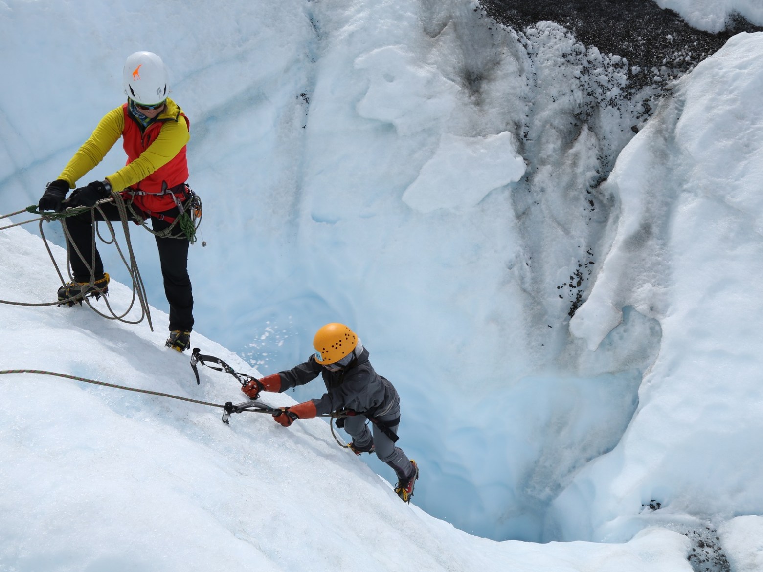 people ice climbing on glacier