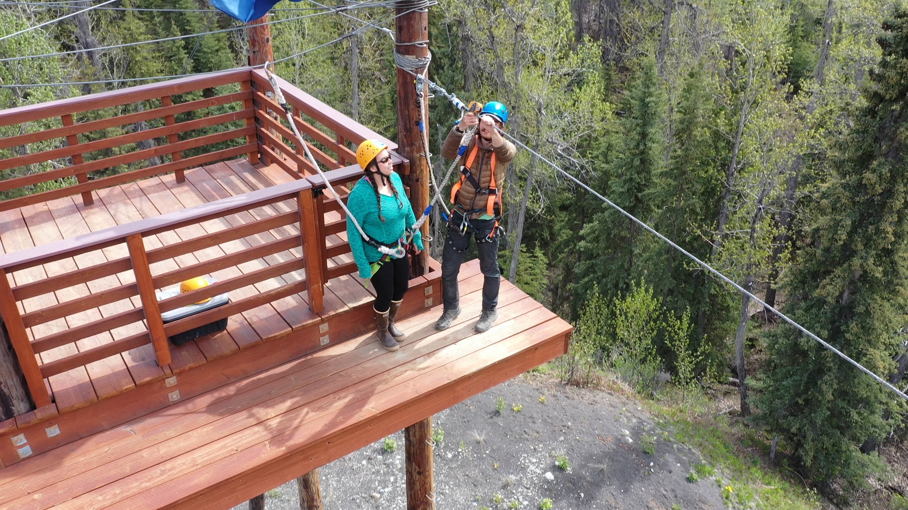 Physics of Zipline zipliner prepares to jump from wood deck