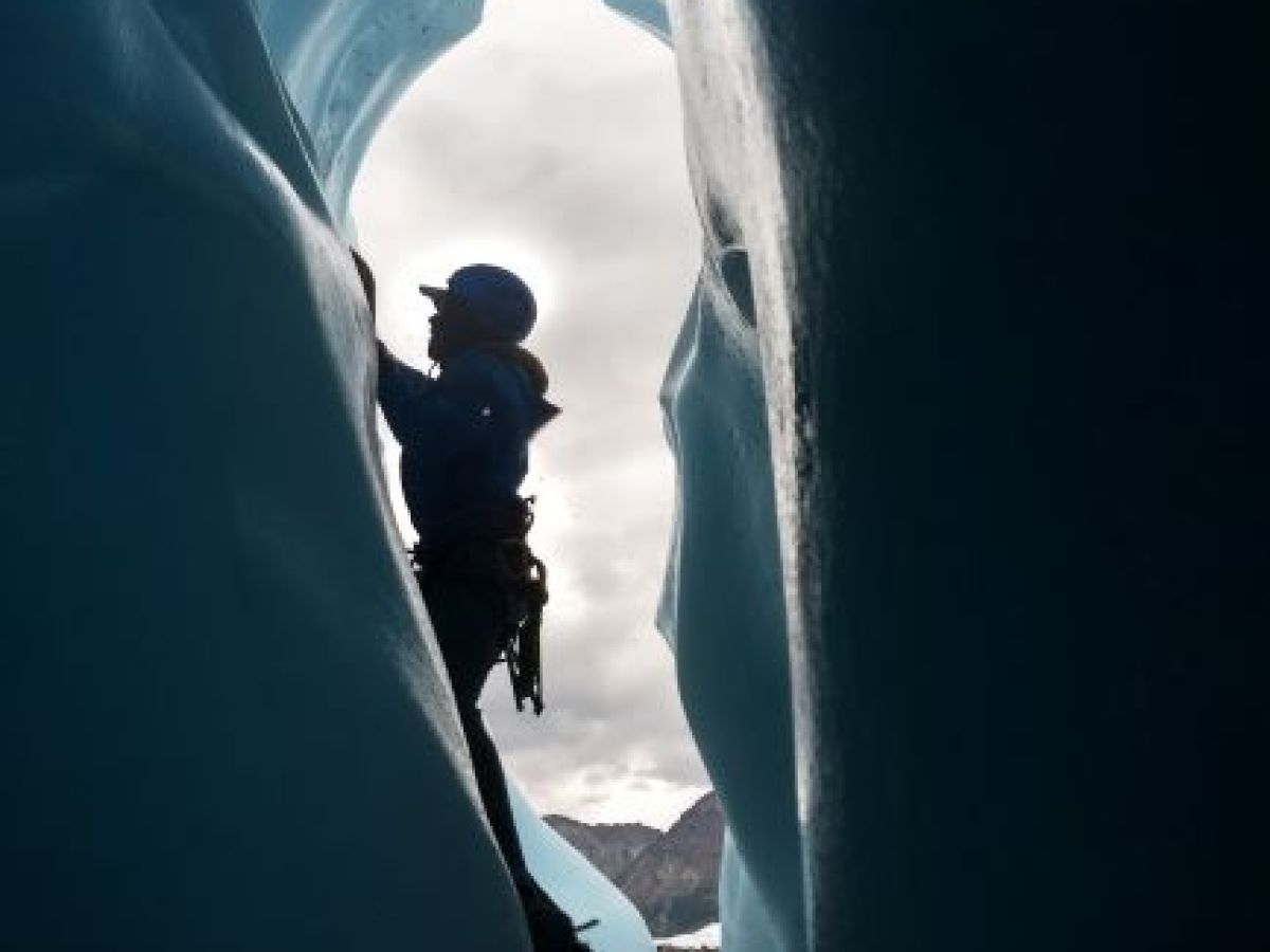 ice climber on ice in the sunlight