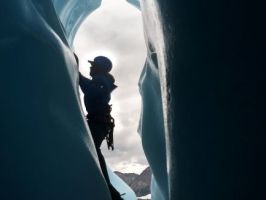 ice climber on ice in the sunlight