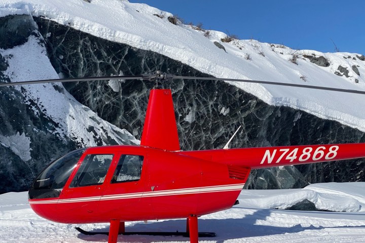 a person sitting on top of a snow covered mountain