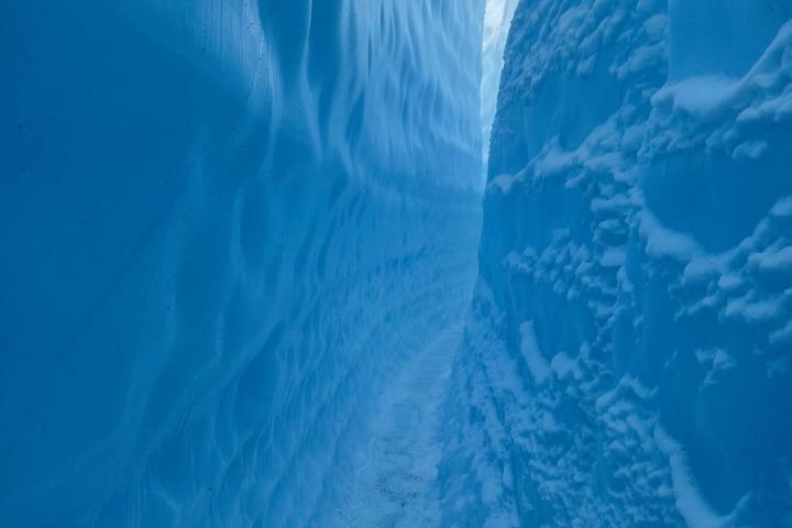 a waterfall with a mountain in the background