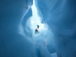 humans climbing in blue ice