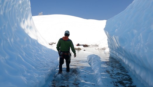 a man standing on top of a snow covered mountain