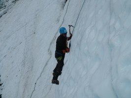 a man riding a snowboard down a snow covered slope