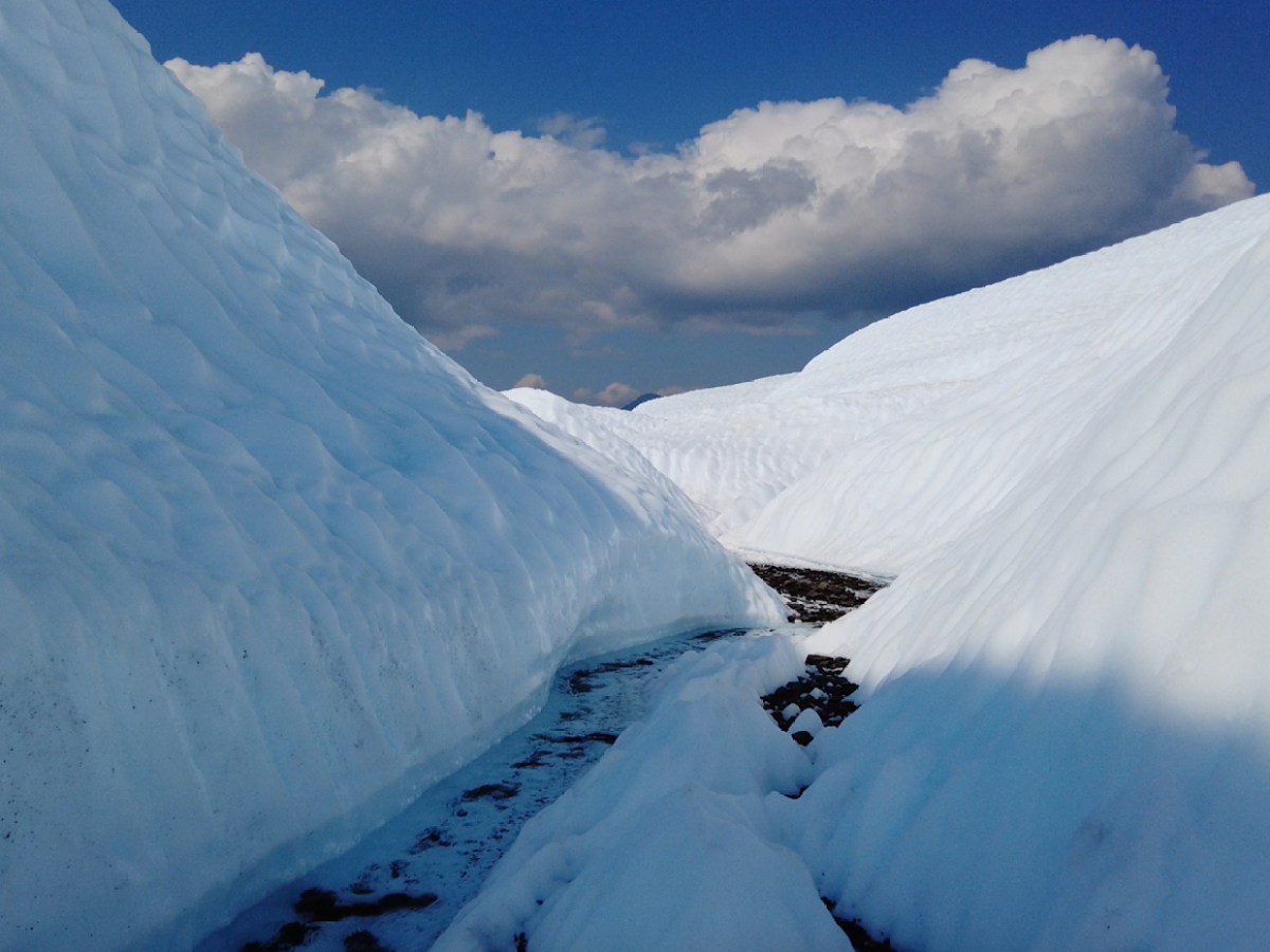 clouds over meltwater and ice canyon