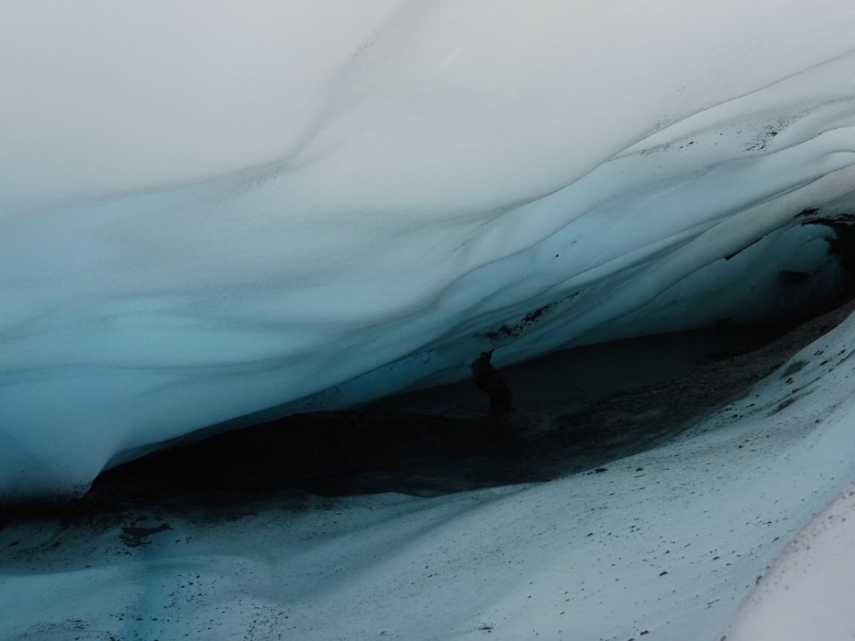 looking into blue wavy ice crevasse