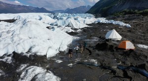 a group of people standing on top of a snow covered mountain