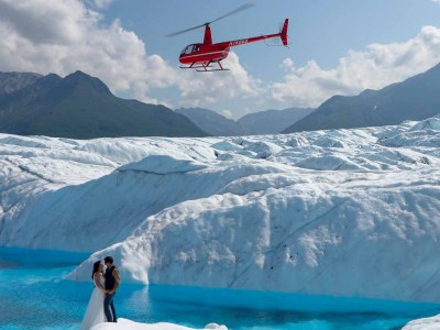 a man flying through the air on a snow covered mountain