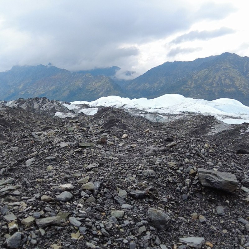 Moraine and white glacier ice near mountains