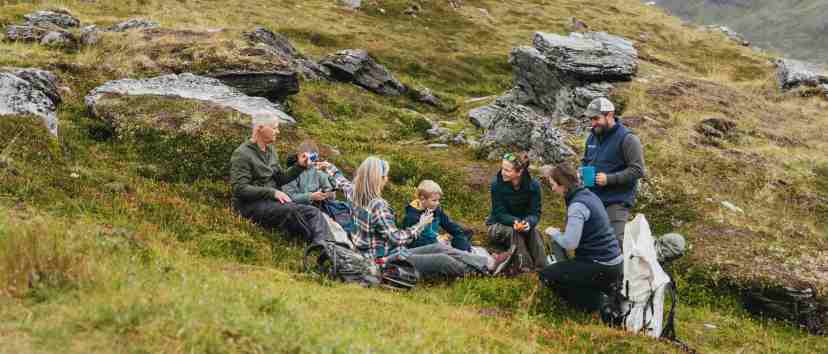 a group of people sitting on a rock